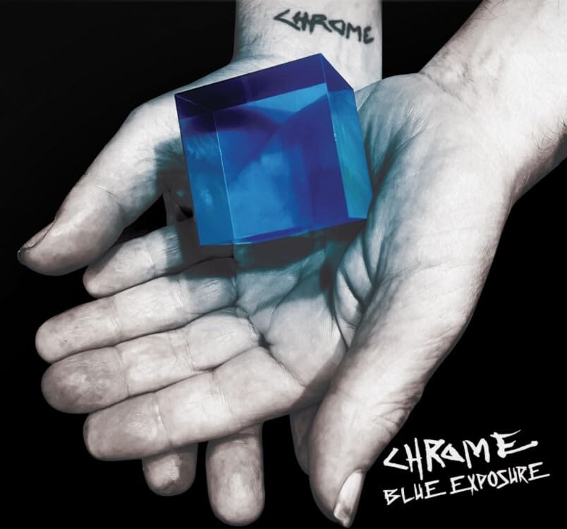 Hand holding a glowing blue crystal cube, album cover for Chrome - Blue Exposure.