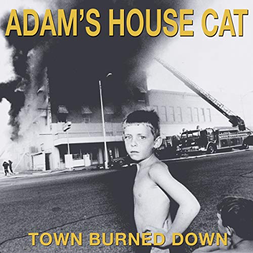 Black-and-white album cover with a boy standing before a burning building and fire truck.