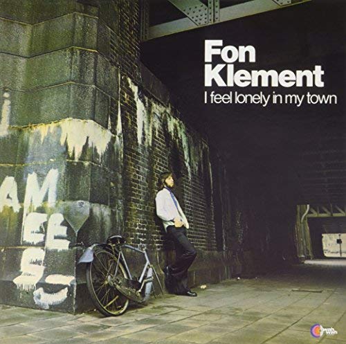 Album cover: man with bicycle leaning against a graffiti wall.