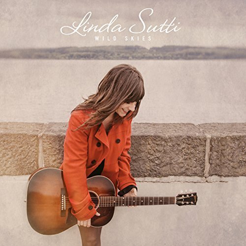 Linda Sutti album cover: woman with guitar, red jacket, sky background.