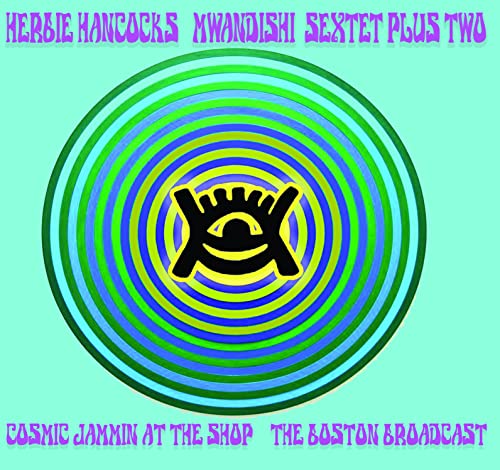 CD cover with concentric rings, a yellow eye symbol, and text.