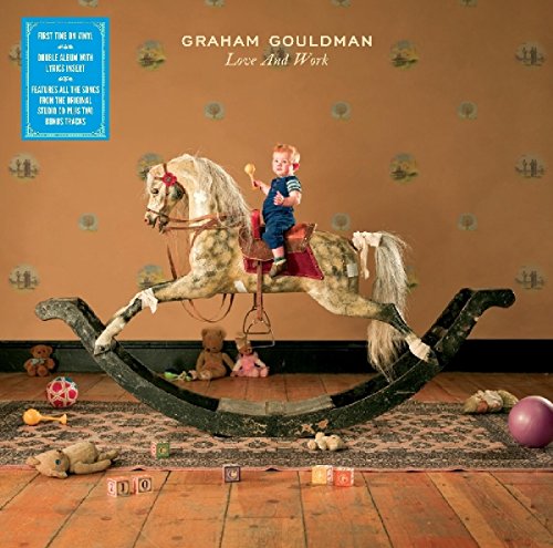 "Album cover featuring a child on a rocking horse, surrounded by toys on a rug."