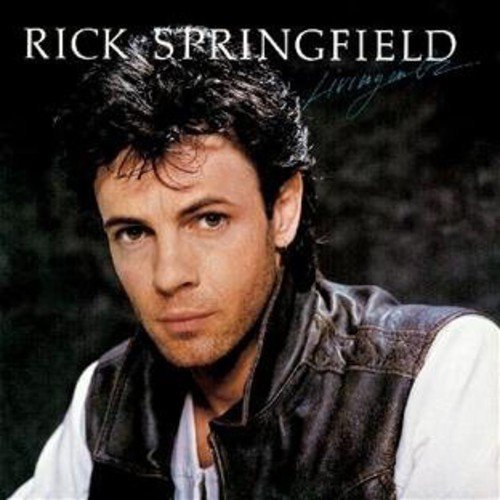 "Album cover featuring Rick Springfield's portrait with dark hair, white shirt, and black vest."