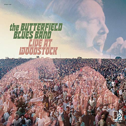 "Album cover featuring a large crowd and a musician's portrait, with green and red text."