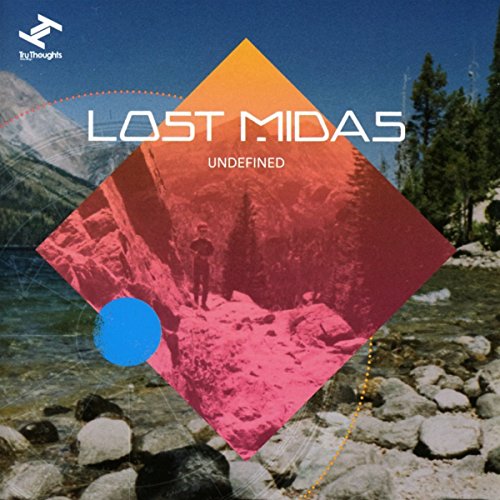 CD cover: mountains, diamond shape, and a lone figure walking.