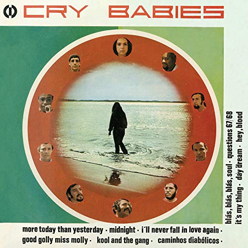 "Cry Babies vinyl album cover featuring a person surrounded by faces on a beach."
