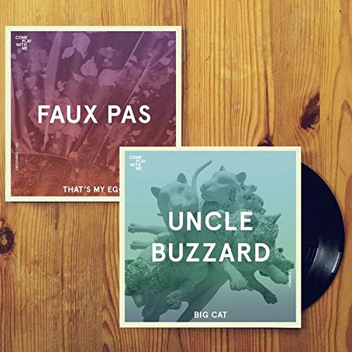 Two vinyl record sleeves on a wooden surface, one partially covering a black vinyl record.