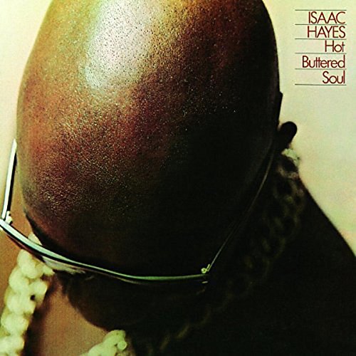 Vinyl record cover featuring a bald man wearing sunglasses and a beaded necklace.