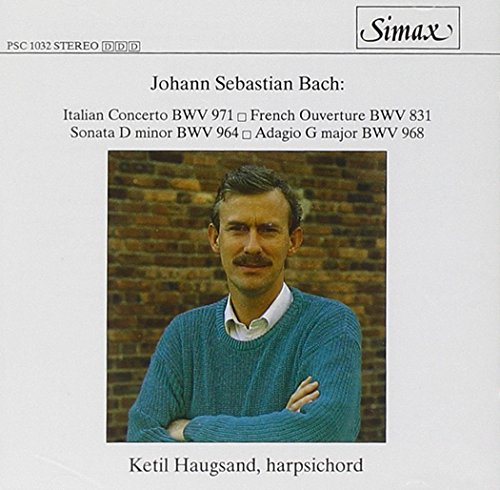 CD cover with a man in a blue sweater against a brick wall.