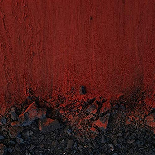 Red and black textured vinyl record cover with rocky foreground.