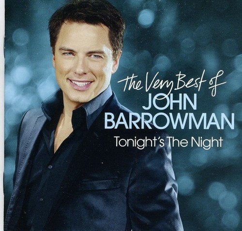 "CD cover featuring John Barrowman smiling, with title text on a bokeh background."