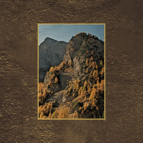 Mountain landscape with trees in autumn colors, framed in gold.