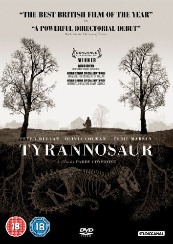 DVD cover for "Tyrannosaur" with a person standing between bare trees and dinosaur skeleton.