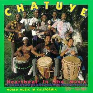 Album cover with 10 men playing drums, surrounded by green border and yellow lettering.