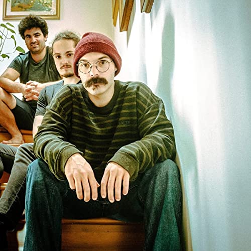 CD cover featuring three men with mustaches on wooden stairs.