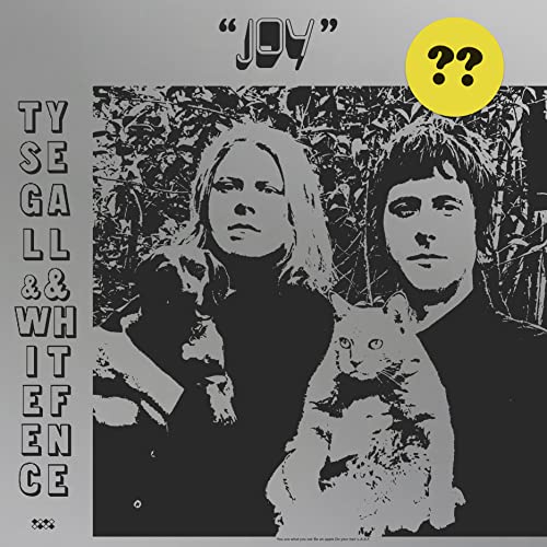 Black and white album cover featuring two people and a cat.