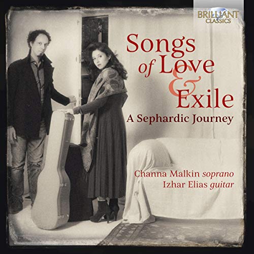 "CD cover with sepia-toned image of man and woman holding guitar case."