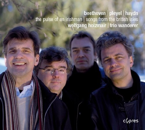 "CD cover featuring four men, likely musicians, with text overlay."