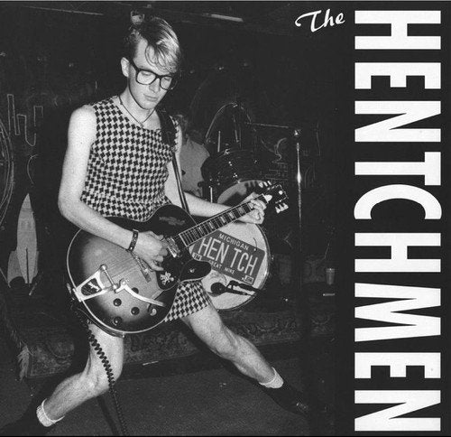 Black and white album cover featuring a musician playing guitar onstage.
