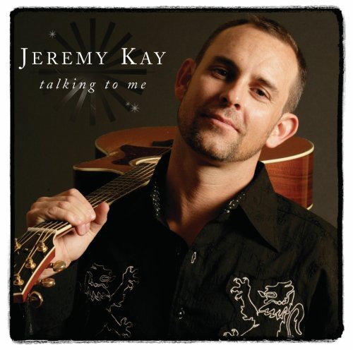 "Album cover of Jeremy Kay holding a guitar, wearing a black embroidered shirt."