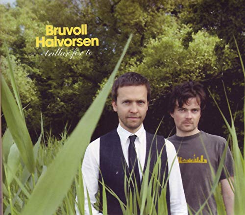 "Album cover featuring two men standing in tall grass with trees in the background."