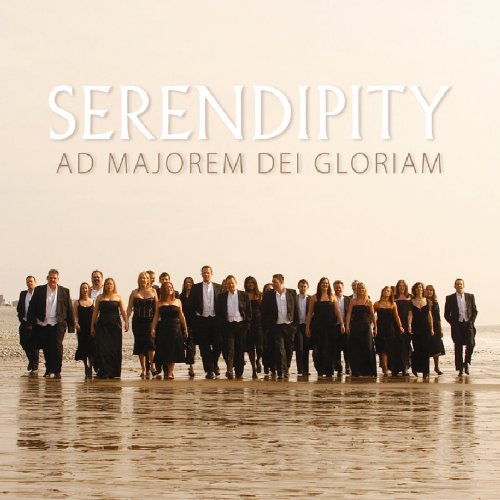A choir in formal attire standing on a wet beach, with text above.