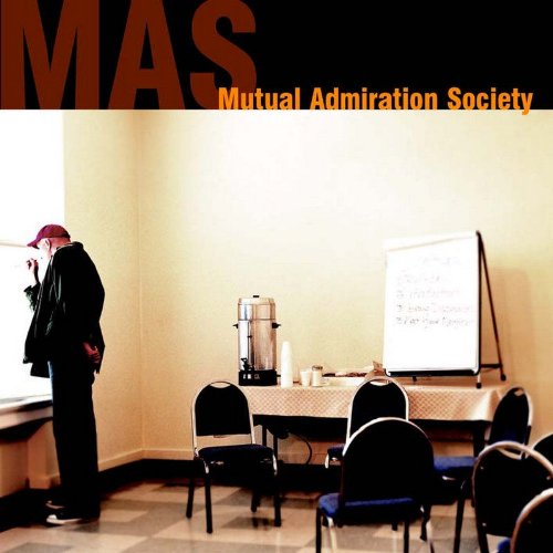 "CD cover with man in black suit standing by a presentation screen."