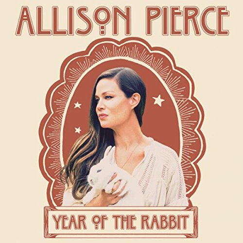 Album cover featuring a woman holding a white rabbit, ornate red frame.