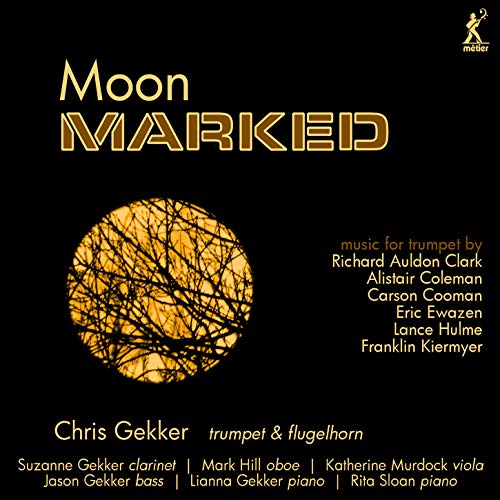 "Album cover with a black background, yellow moon, and tree branches, featuring 'Moon Marked' title."
