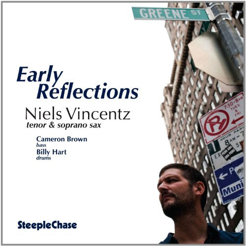 "Album cover with man standing by street signs and 'Early Reflections' title."