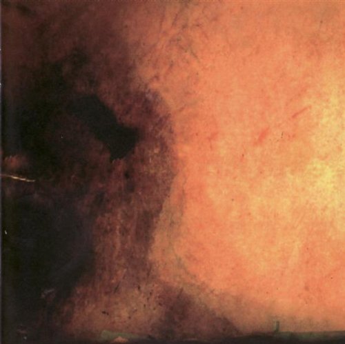 Abstract orange and brown textured CD cover with distant buildings.