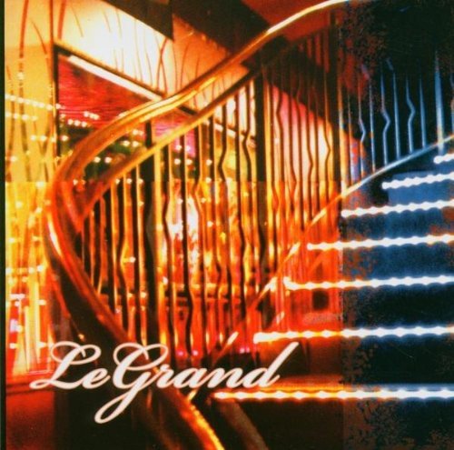 Spiral staircase with warm lighting, album cover text “Le Grand”.