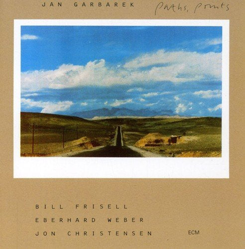 "Album cover with a photo of a desert road on a beige background."
