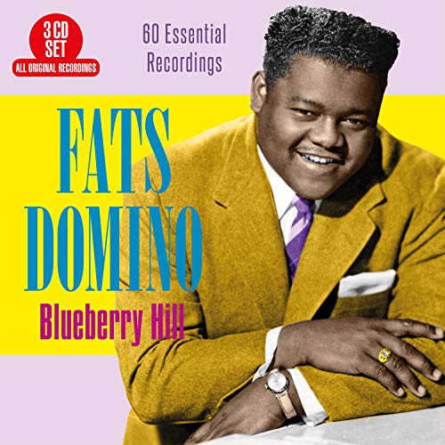 "Fats Domino in a yellow suit on a CD album cover."