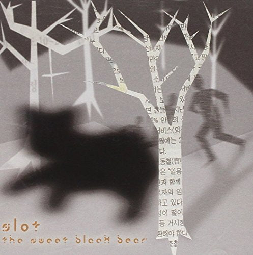 CD cover: Silhouetted bear with paper tree branches in grayscale.