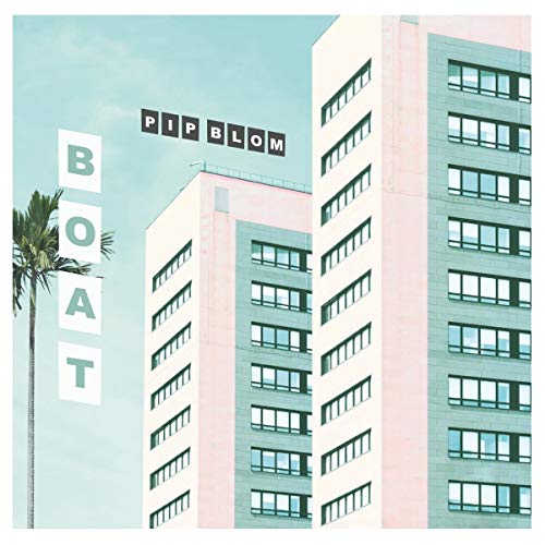 Album cover for Pip Blom’s “Boat” featuring buildings and a palm tree.