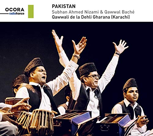 "Three men in traditional attire play instruments and sing with raised hands."