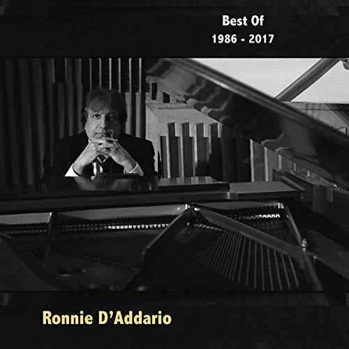Black and white album cover featuring a man sitting at a grand piano.