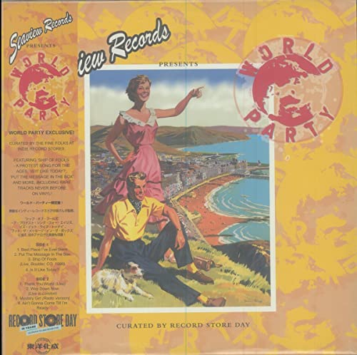 Vinyl record cover: couple pointing at a coastal town scene.