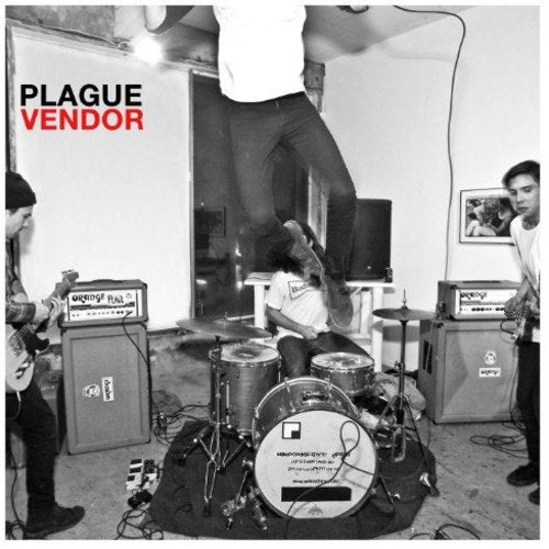 Black and white album cover with musicians playing instruments in a room.