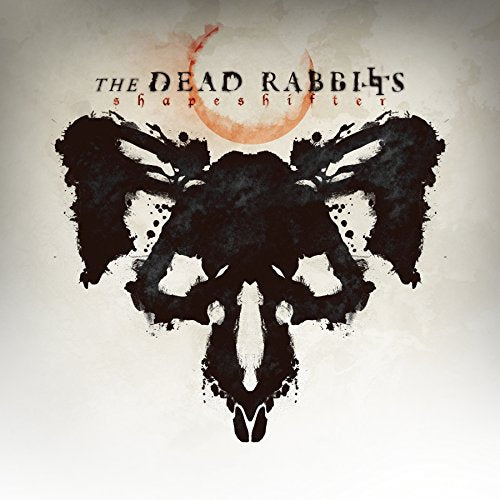"Album cover with a black rabbit silhouette and orange moon on a gray background."