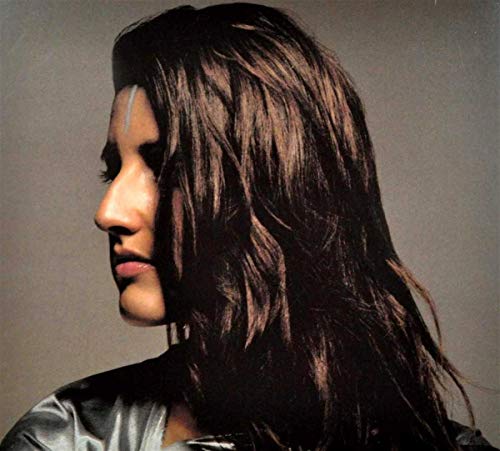 Close-up of a person with long dark hair and a white facial stripe.