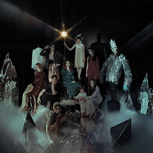 Album cover featuring a group of people in various poses amidst fog and dark background.