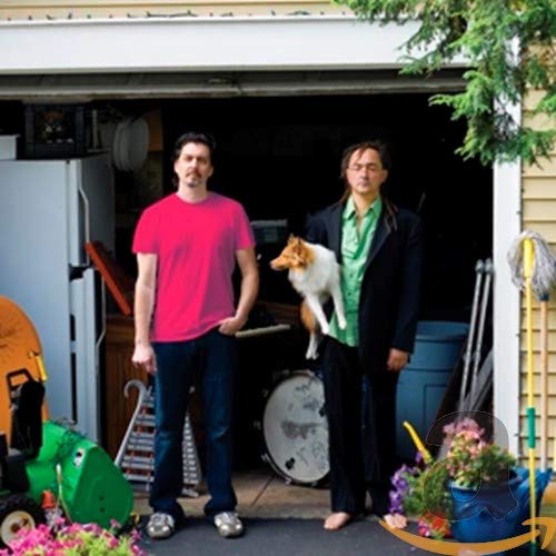 CD cover featuring two men and a dog in front of a garage.