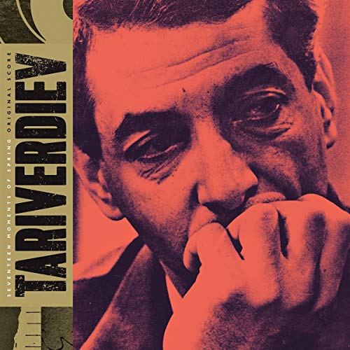 CD cover featuring a close-up, red-toned portrait of a man’s face.
