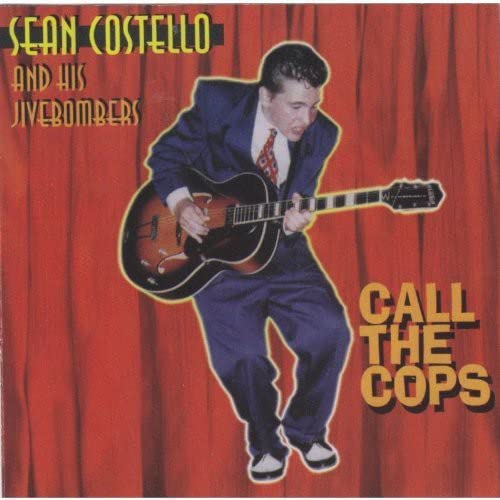 Sean Costello playing guitar in a suit, album cover for "Call The Cops".