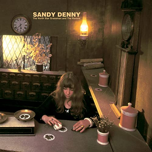 Sandy Denny album cover with a woman and vintage interior details.