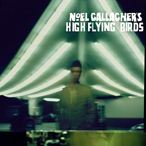 "Blurry album cover with man standing under triangular neon lights, text 'Noel Gallagher's High Flying Birds'."