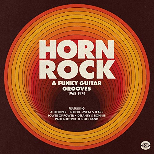 Vinyl record cover with orange and brown concentric circles and bold text.
