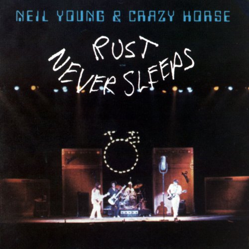 "Album cover featuring Neil Young and band performing on stage under spotlights."
